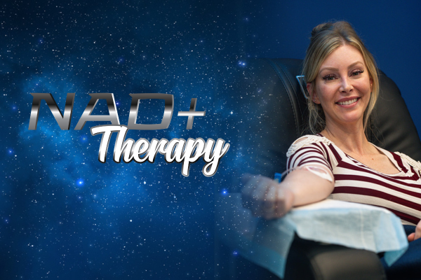 A smiling woman seated in a chair donating blood